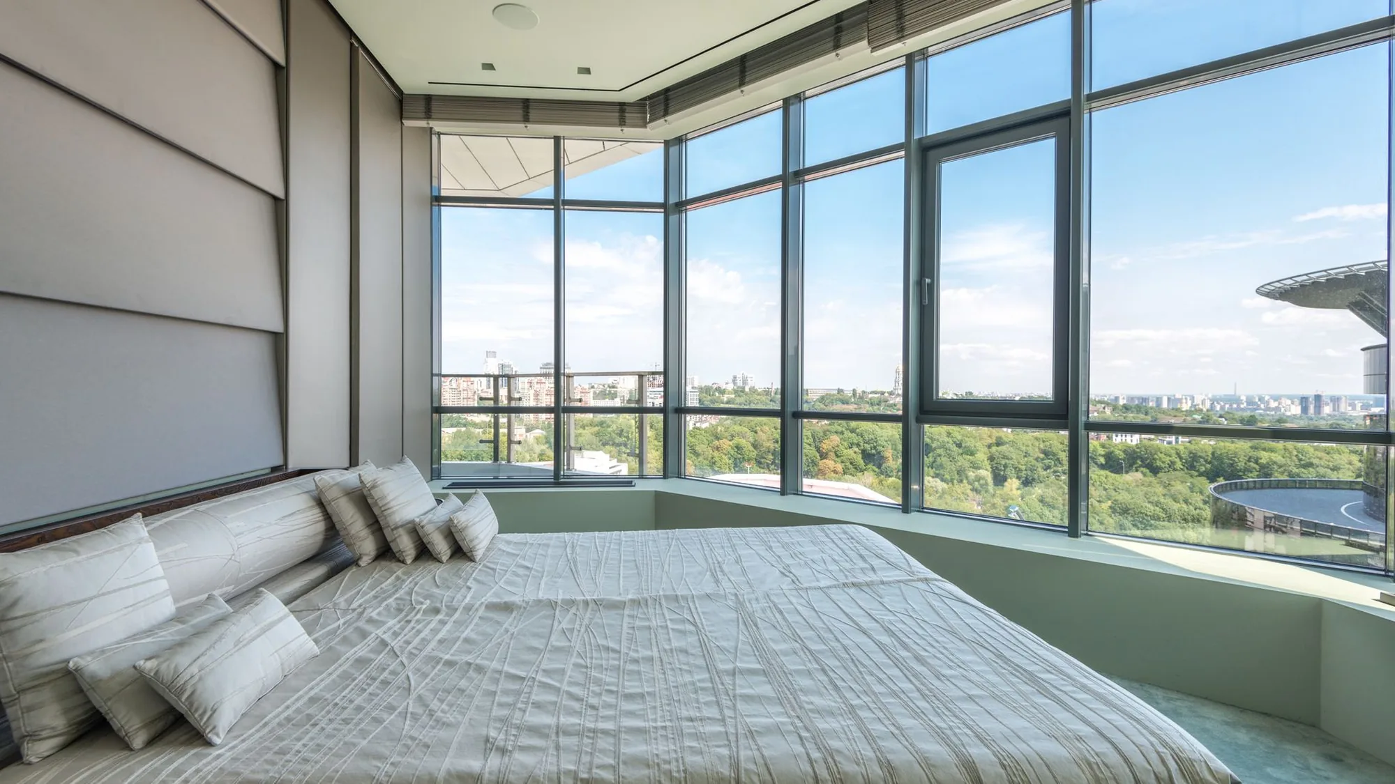 Hotelkamer met een glasgevel van vloer tot plafond en uitzicht